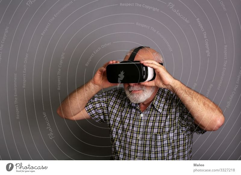 Man wearing virtual reality glasses. Studio recording, grey background Really Virtual VR Eyeglasses Panorama (Format) Playing Technology gadget Digital