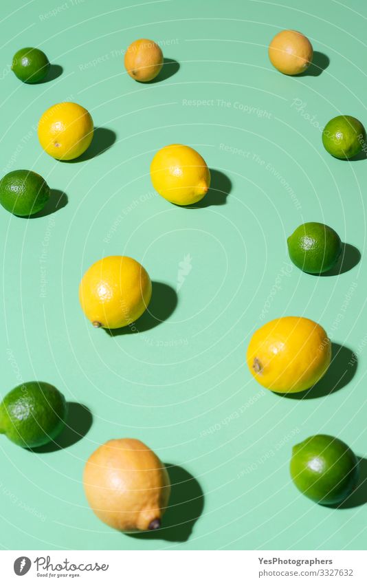 Lemons and limes fruits on a green background. Summer fruits Food Fruit Breakfast Beautiful weather Fresh aqua menthe cheerful Citrus fruits colorful