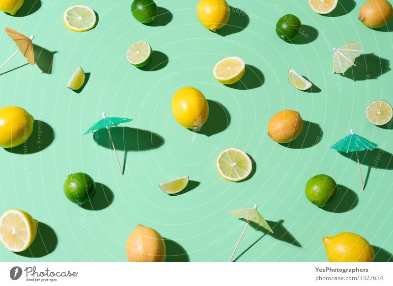 Limes, lemons and cocktail umbrellas. Summer background Food Fruit Beautiful weather Fresh aqua menthe cheerful Citrus fruits cocktail ingredients colorful