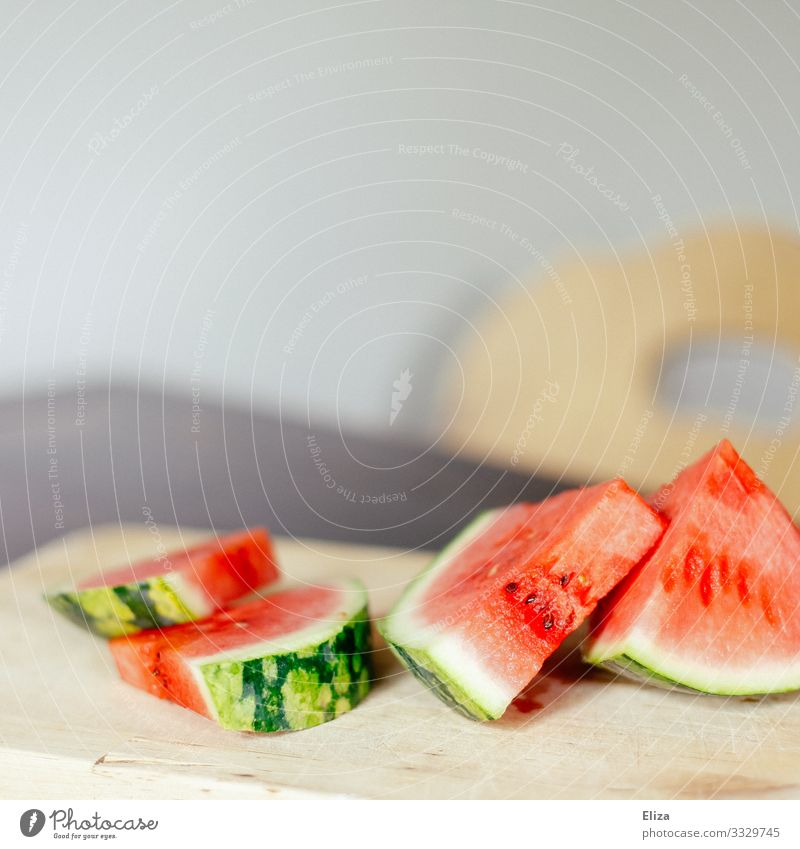 Sliced watermelon on a wooden cutting board on a table Food Fruit Delicious Water melon Wooden board Sweet Fruity Fresh Summery Red Melon Kitchen Table Snack