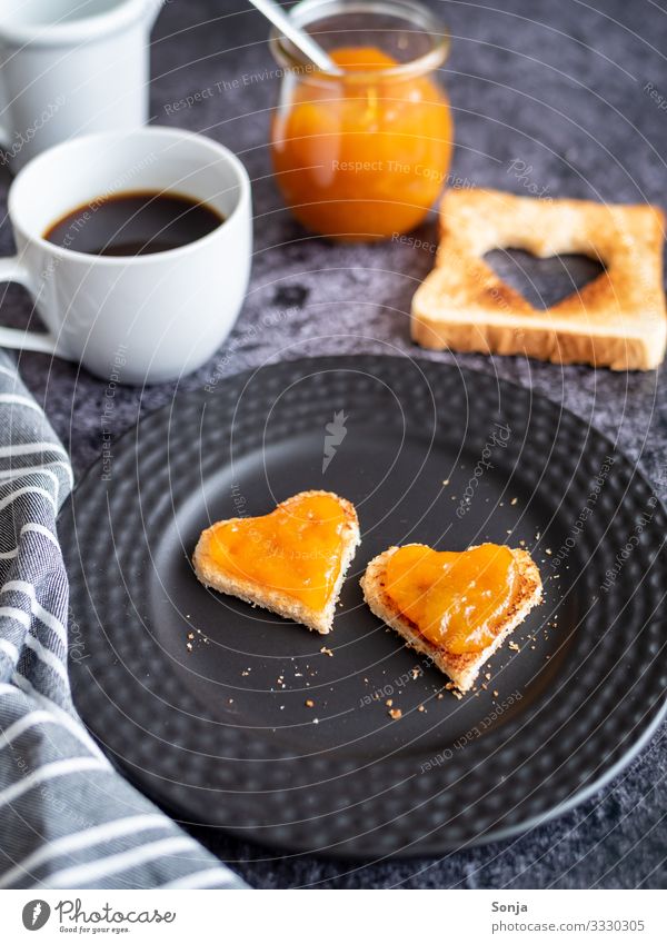 Breakfast with heart-shaped toast and apricot jam Food Bread Jam Toast Nutrition To have a coffee Beverage Hot drink Coffee Plate Cup Glass Table