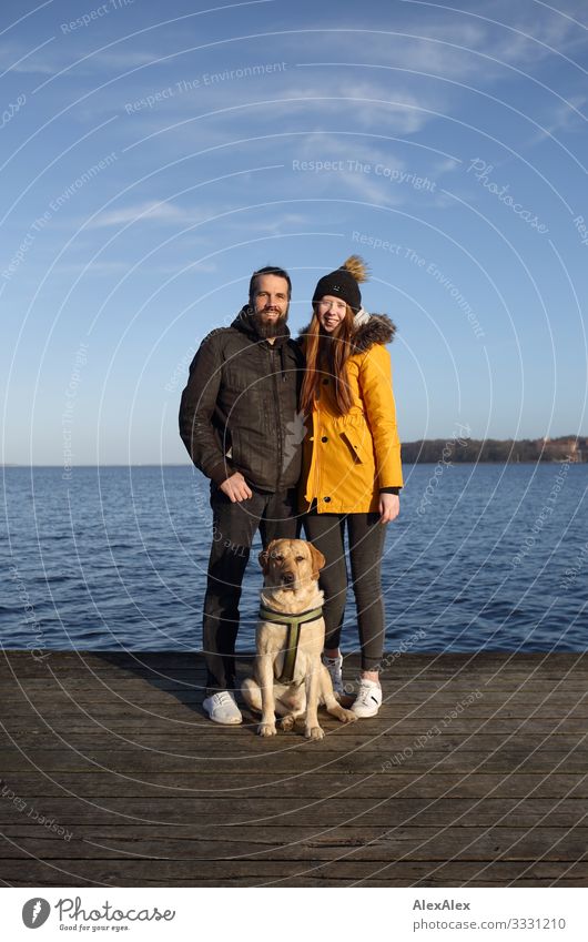 Couple with blond Labrador on jetty at the Baltic Sea Lifestyle Joy Happy Beautiful Harmonious Trip Ocean Young woman Youth (Young adults) Man Adults