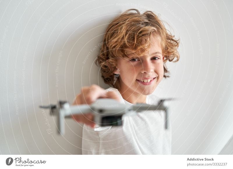 Child manipulating a drone and the remote control just given to him filming hobby robot motion aerial technology photography pilot discovery video sky operator