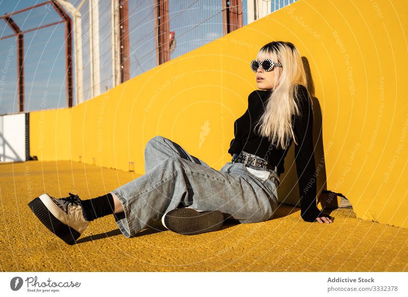 Calm young woman enjoying sunlight on stadium lay relaxation freedom carefree lifestyle female confident ground hipster colorful beauty individuality