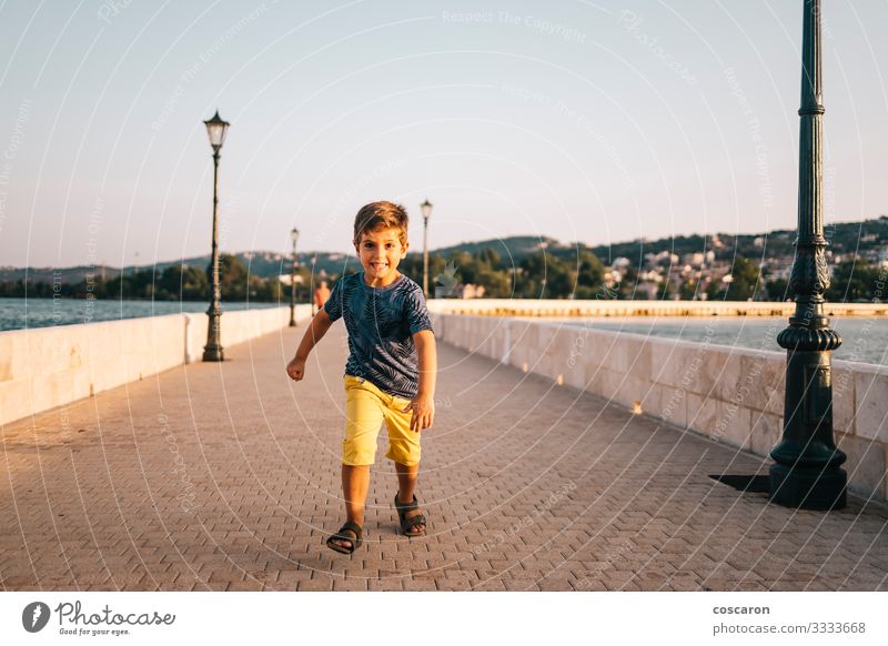 Athletic kid running on a bridge in Argostoli, Greece. Lifestyle Joy Happy Healthy Leisure and hobbies Playing Vacation & Travel Summer Beach Ocean Sports