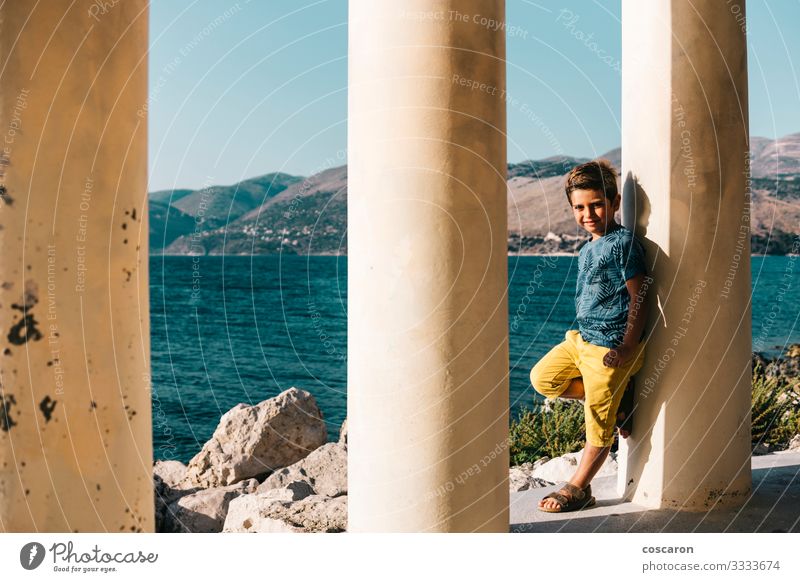 Little kid supported on a column near the sea Lifestyle Happy Beautiful Leisure and hobbies Vacation & Travel Summer Beach Ocean Child Human being Masculine