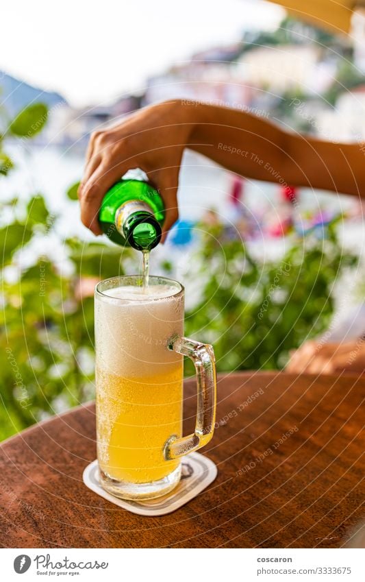 Hand filling a glass of beer on a terrace Beverage Alcoholic drinks Beer Bottle Lifestyle Vacation & Travel Tourism Summer Summer vacation Beach Ocean Table