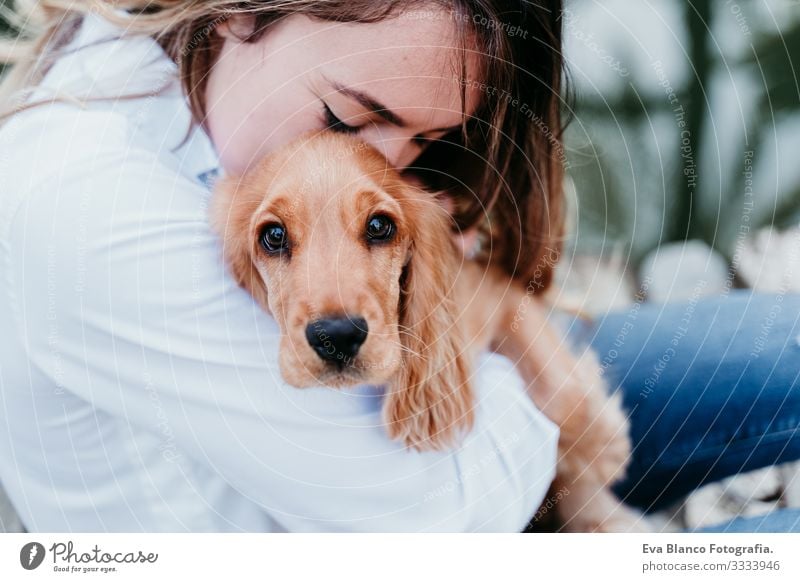 young woman and her cute puppy of cocker spaniel outdoors Woman Dog Pet Park Sunbeam Exterior shot Love Embrace Smiling Rear view Kissing Breed Purebred