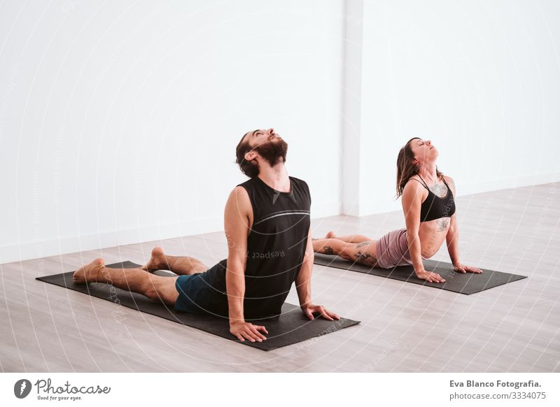 young man and woman practicing yoga sport at the gym. Healthy lifestyle Yoga Man Boy (child) Sports Lifestyle Interior shot Gymnasium Studio shot White hispanic