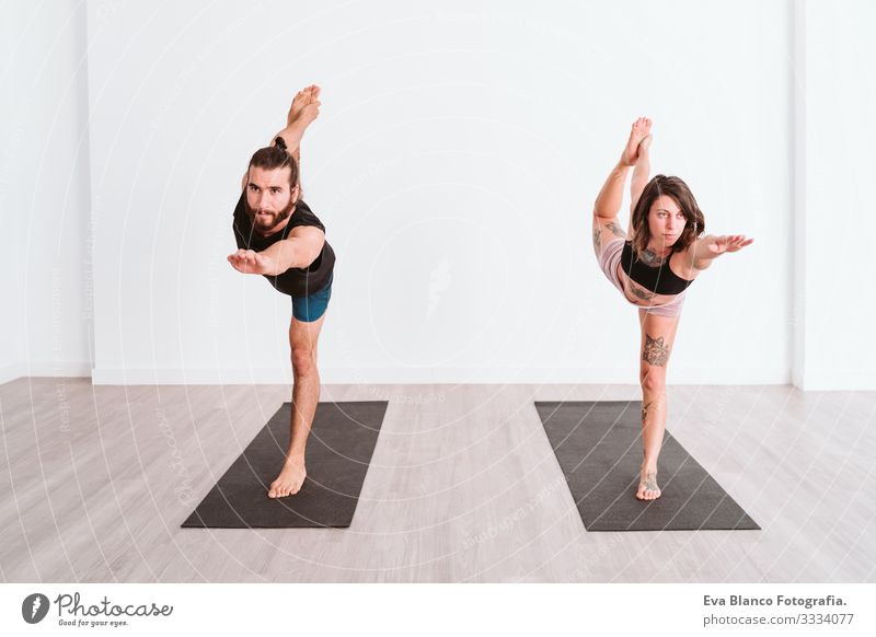 Flexible lady training upside down in studio - a Royalty Free Stock Photo  from Photocase