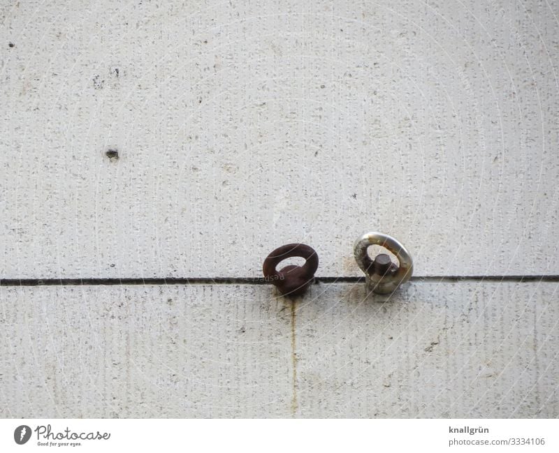 Two eyebolts in a joint on a house facade Screw Eyebolt Facade House (Residential Structure) Side by side Couple Bright Dark Exterior shot Deserted Day