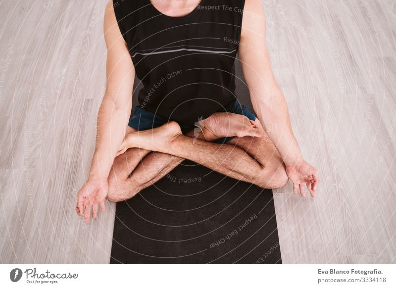 young man practicing yoga sport at the gym. Healthy lifestyle. top view - a  Royalty Free Stock Photo from Photocase