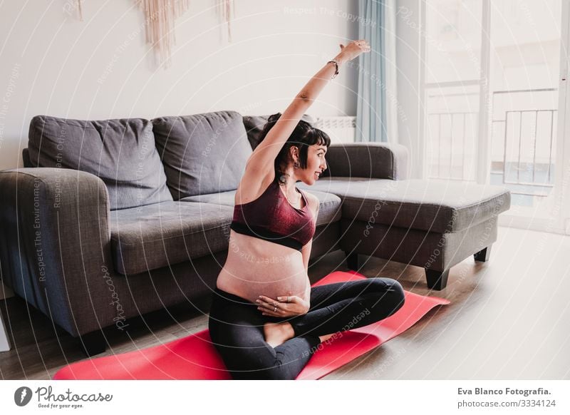 young pregnant woman at home practicing yoga sport. healthy lifestyle Pregnant Woman Yoga Home Sports Healthy Lifestyle Youth (Young adults) Caucasian Parenting