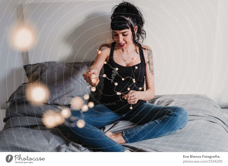 young pregnant woman at home working on laptop and drinking water Pregnant Woman Home Paper chain Light Christmas & Advent Smiling Happy Portrait photograph