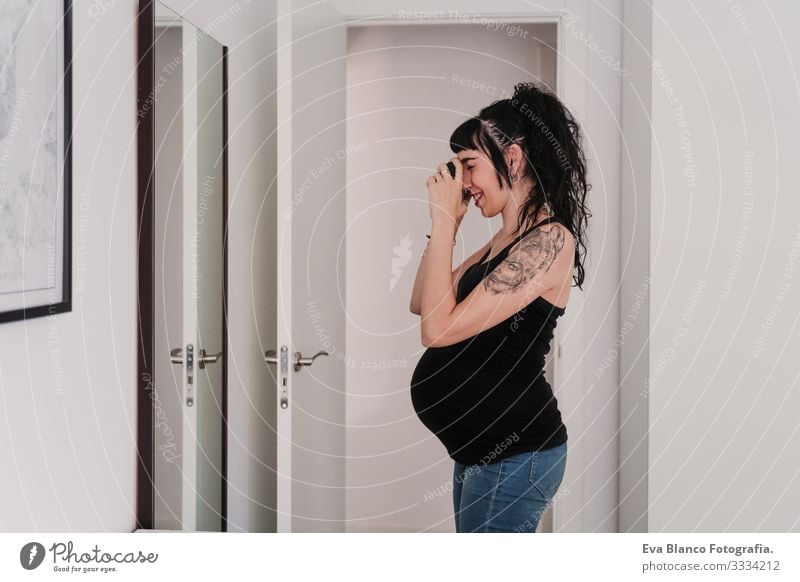 young pregnant woman at home taking a selfie on mirror with camera Pregnant Woman Illustration Camera Mirror Home Smiling Happy Portrait photograph