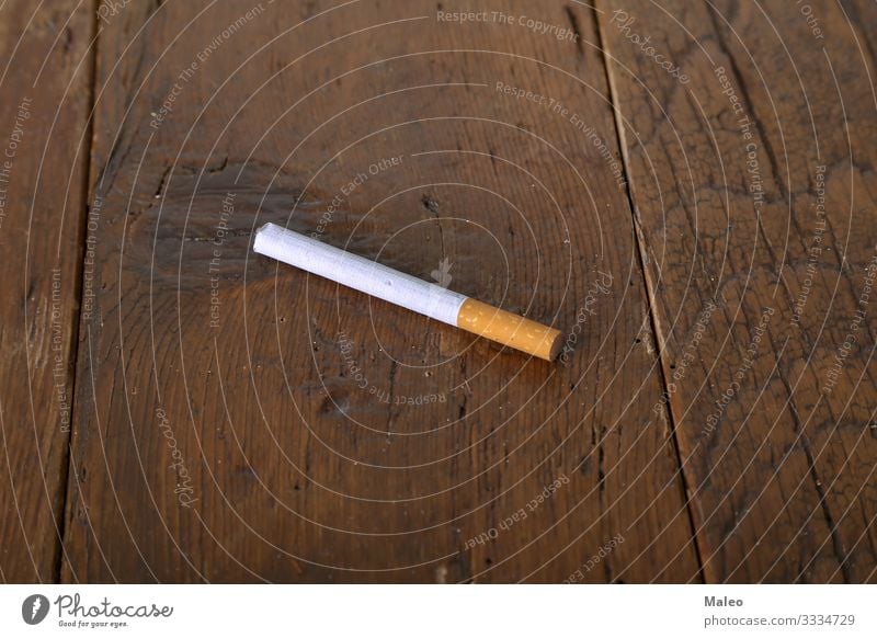 Filter cigarette lies on a wooden table Addiction Cigarette Concepts &  Topics Health care Lifestyle Smoke Tobacco Close-up Consumption Costs Industry Leaf
