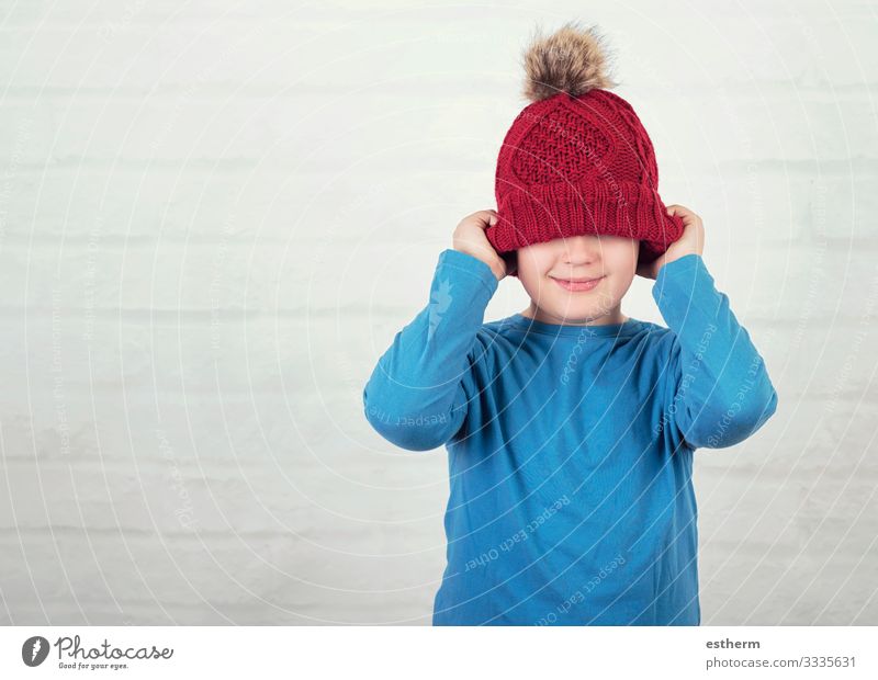 funny child with winter hat Lifestyle Joy Leisure and hobbies Winter Human being Masculine Child Toddler Infancy 1 8 - 13 years Weather Hat To hold on Smiling