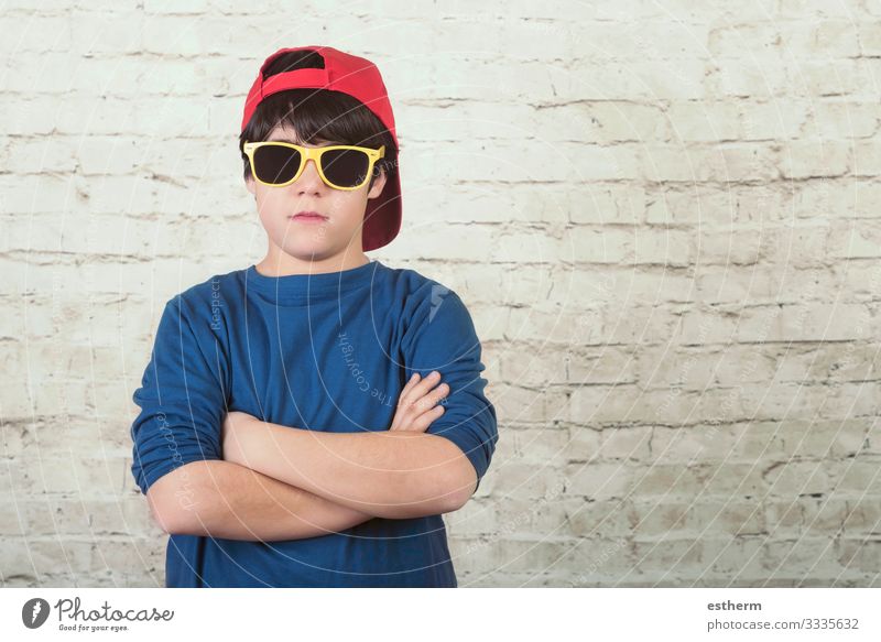 angry boy with sunglasses and cap Freedom Human being Masculine Child Toddler Infancy 1 8 - 13 years Sunglasses Cap Fitness Sadness Gloomy Anger Concern