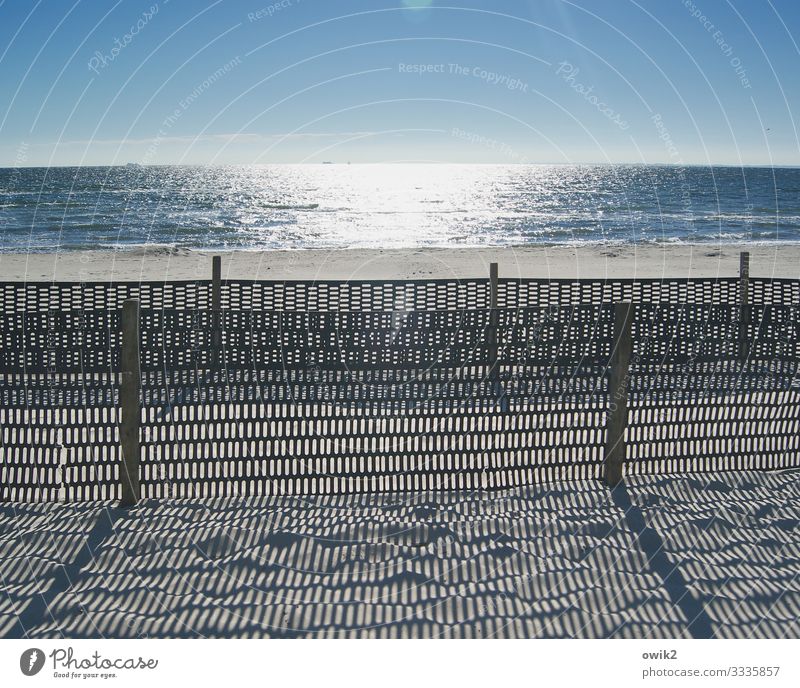 restricted area Environment Landscape Sand Water Cloudless sky Horizon Beautiful weather Coast Beach Baltic Sea Fence Fence post Barrier Boundary Wood Plastic