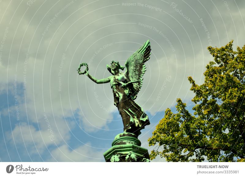 Sculpture of the goddess of victory Victoria with wings and in a flowing garment throwing a victor's wreath. Bronze casting of an original by Christian Daniel Rauch (1777-1857)