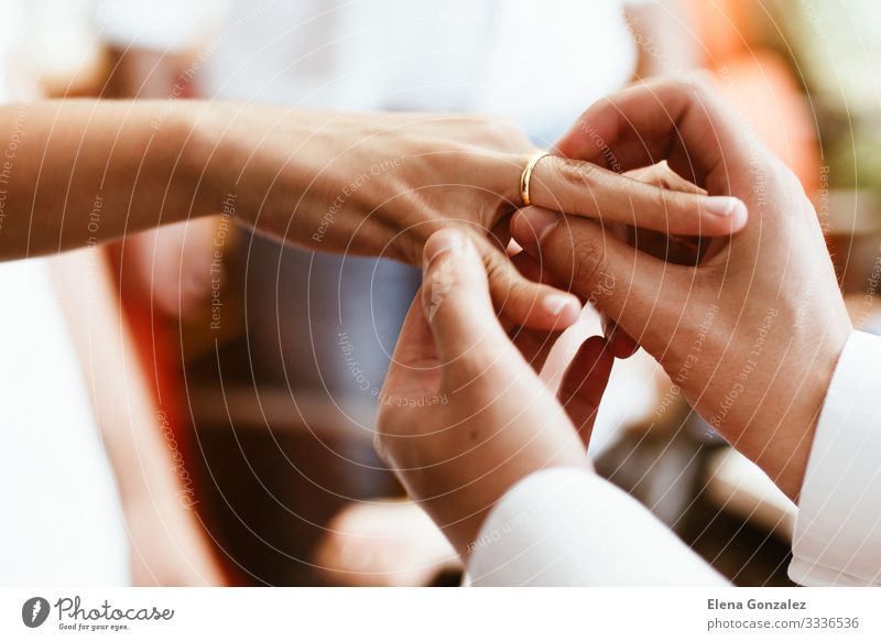 Man putting wedding ring on woman finger. Feasts & Celebrations Wedding Woman Adults Hand Fingers Love Together Emotions Trust Relationship Eternity Future