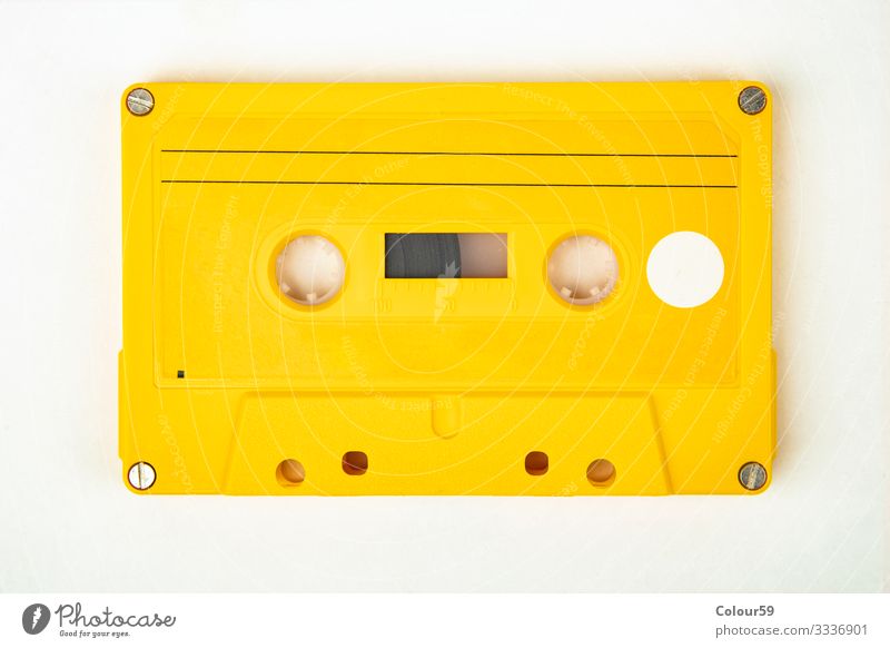 Yellow music cassette Music Retro Tape cassette audio Vintage 80s Background picture recording Analog free time tape Colour photo Studio shot