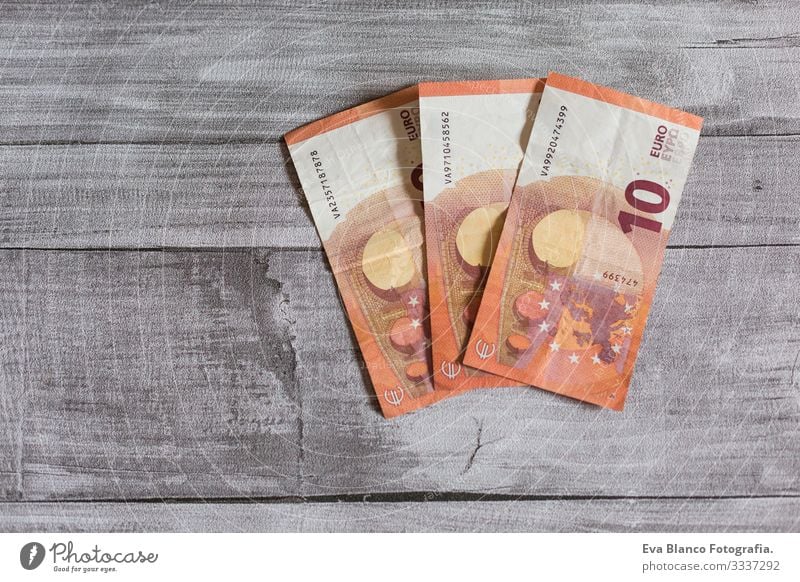 Three euro ten bill. Euro bank notes on grey wood background. Money concept wealth Stack Income wages salary Numbers Sell earnings Accumulation
