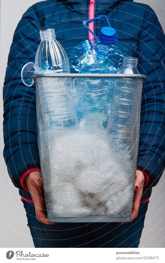 Woman holding trash bin with collected used plastic packagings Bottle Adults 1 Human being Environment Container Package Plastic Throw Blue