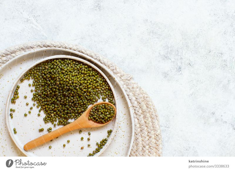 Dried mung beans with a spoon on a white table Vegetarian diet Diet Plate Spoon Table Above Green Beans fiber food health ceramic healthy Ingredients Kidney