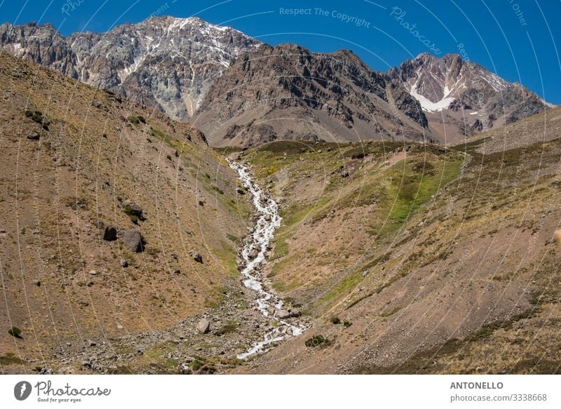 Andean mountain landscape with stream Environment Nature Landscape Earth Sky Summer Climate change Snow Hill Rock Mountain Andes the cordillera of the andes