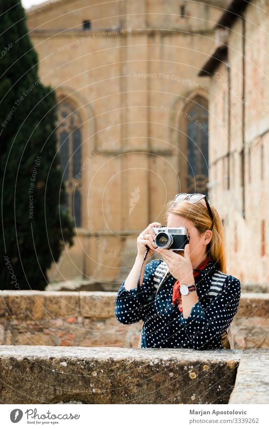 Young woman taking a photo in an old town in Italy Lifestyle Vacation & Travel Tourism Trip Sightseeing Camera Human being Feminine Youth (Young adults) Woman
