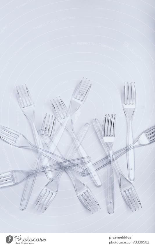 Plastic forks scattered over white background Cutlery Fork Save Environment Container Crystal Blue White Environmental pollution Trash garbage recycle Recycling