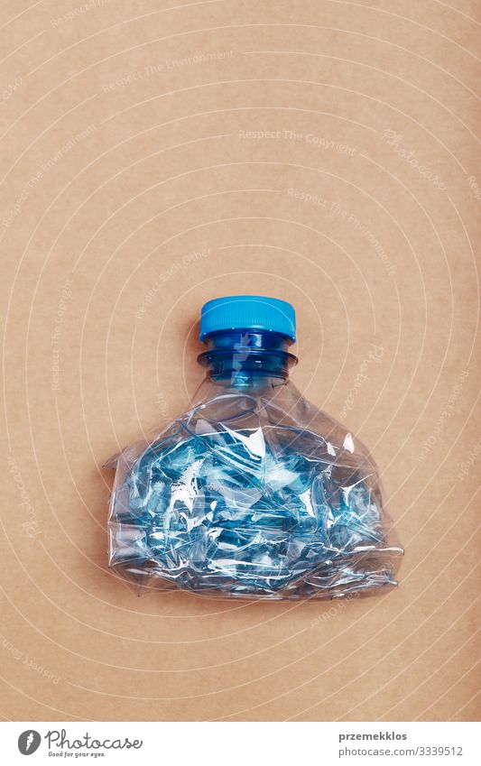 Squashed empty plastic bottle Bottle Save Environment Container Paper Plastic Blue Brown Environmental pollution Environmental protection Destruction Trash