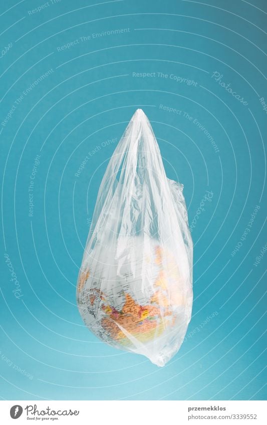 Globe in a plastic bag. Earth contaminated by plastic waste Save Life Environment Plastic packaging Sphere Blue Green Environmental pollution