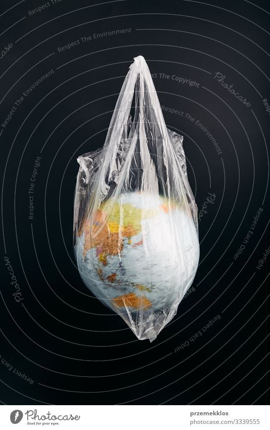 Globe in a plastic bag. Earth contaminated by plastic waste Save Life Environment Plastic packaging Sphere Green Environmental pollution