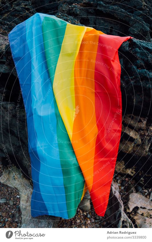 Gay pride flag on a rocky background Freedom Beach Feasts & Celebrations Wedding Human being Homosexual Family & Relations Friendship Partner Wind Stripe Flying