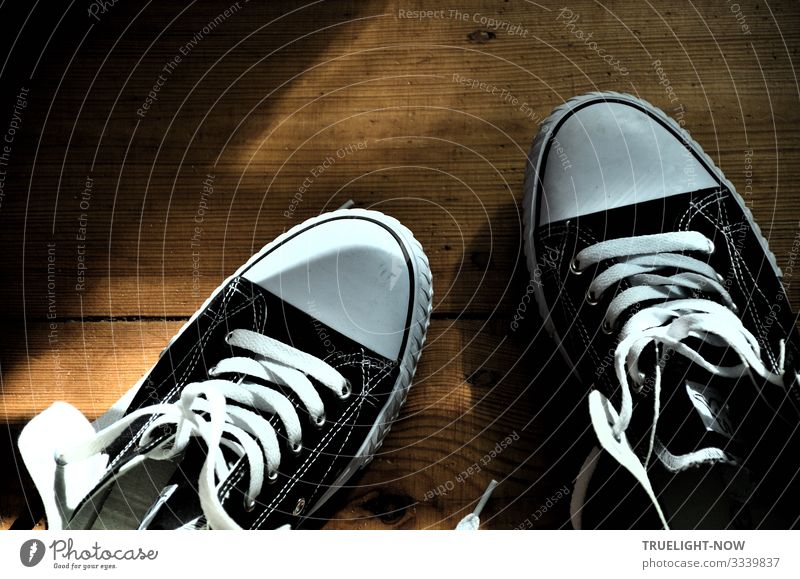 Black and white sneakers on wooden floor with sunlight and shade Sneakers Chucks Shoelace black-white Wooden floor planks Sunlight Shadow New Open slack