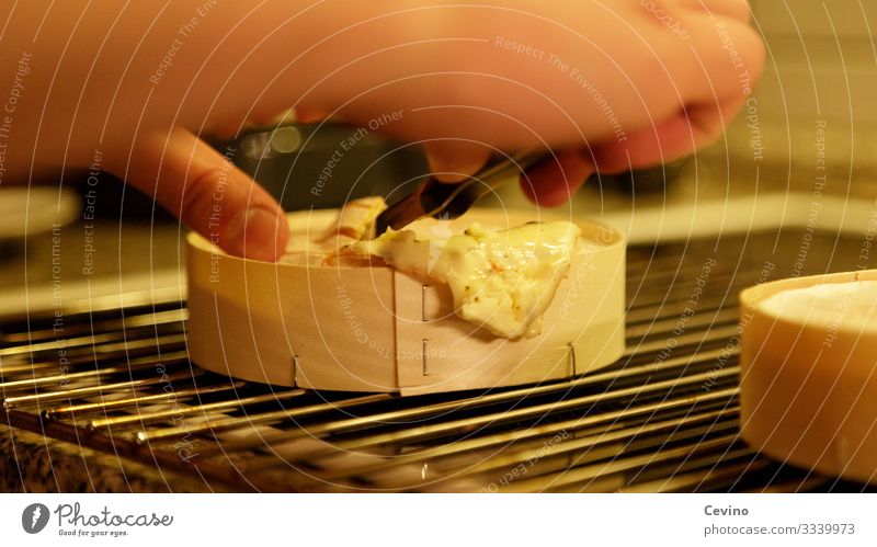 Oven cheese is divided with a knife kiln Cheese oven cheese Delicious Unhealthy Knives Rust Furnace grate Grating Hand Dinner Snack Meal Interior shot hunger