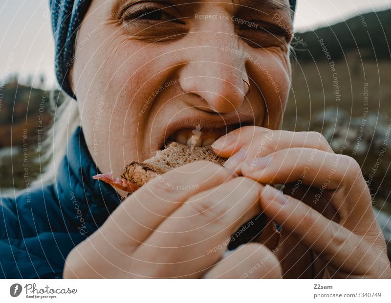 eat sausage bread Hiking Eating snack Sausage sandwich Bread Bite In transit food and drink hunger hands Looking bite off Nature Landscape Sports Nutrition