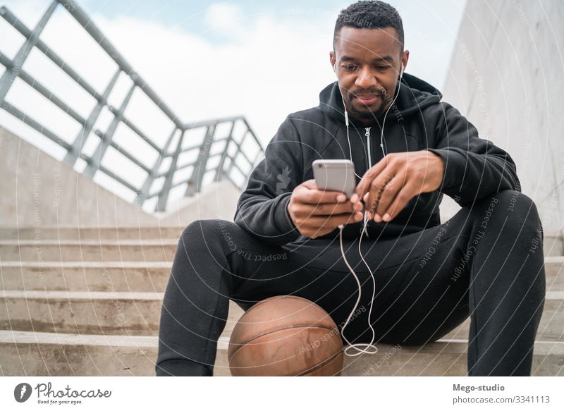 Athletic man using his mobile phone. Lifestyle Leisure and hobbies Sports Telephone PDA Technology Human being Man Adults 1 30 - 45 years Fitness To enjoy