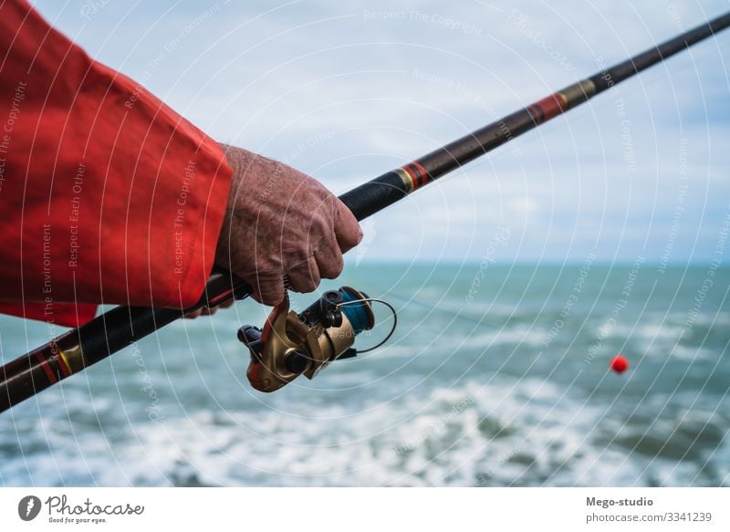Fisherman fishing at the sea. Lifestyle Happy Relaxation Leisure and hobbies Playing Vacation & Travel Ocean Sports Retirement Human being Man Adults Hand 1
