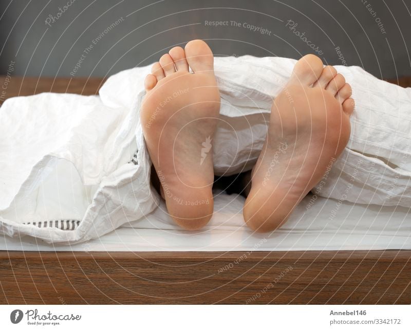 One pair of Feet alone in Bed on White Sheets Skin Relaxation Child School Human being Boy (child) Man Adults Sleep Comfortable Colour bed blanket Barefoot