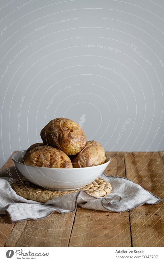 Freshly cooked stuffed potatoes on table filled rustic wooden dish homemade towel food traditional cuisine brown meal plate dinner tasty fresh appetizer baked