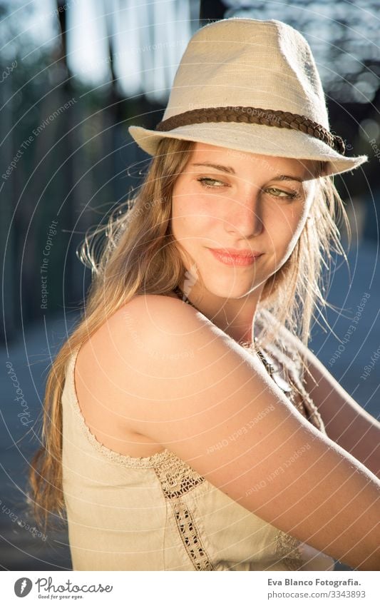 portrait of a young woman at sunset Portrait photograph Youth (Young adults) Woman Exterior shot Happy Blonde Hat blue eyes Bridge Summer Sunbeam Hair Happiness
