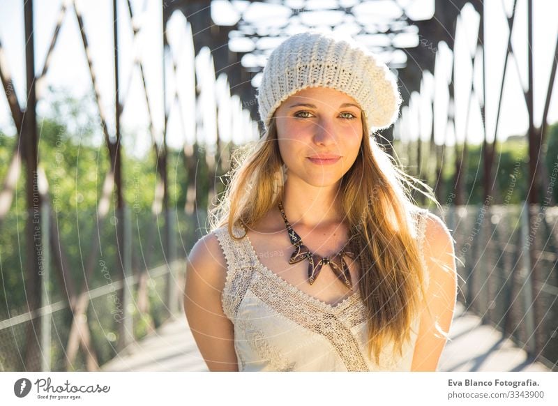 portrait of a young woman at sunset Portrait photograph Youth (Young adults) Woman Exterior shot Happy Blonde Hat blue eyes Bridge Summer Sunbeam Hair Happiness