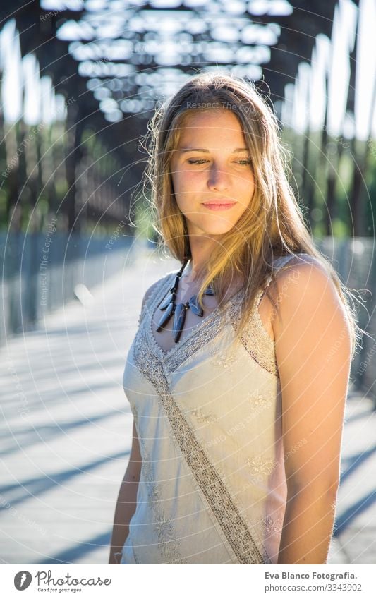 outdoors portrait of a beautiful young woman Portrait photograph Youth (Young adults) Woman Exterior shot Happy Blonde blue eyes Bridge Summer Sunbeam Hair