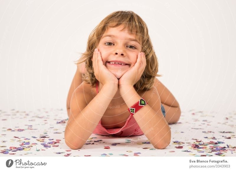 little girl portrait. indoors, confetti on the floor. white background Portrait photograph Joy Child Cute lifestyle happiness Cheerful Beautiful Small Hair