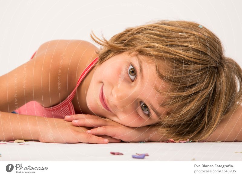 kid having fun on the floor close up portrait, white background Portrait photograph Joy Child Cute lifestyle happiness Cheerful Beautiful Small Hair