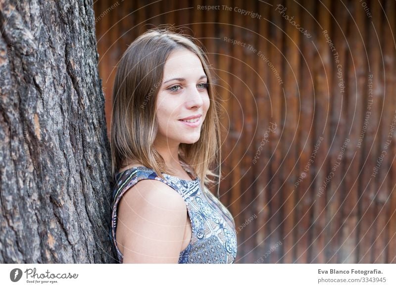 outdoors portrait of a beautiful young woman looking at the camera and smiling. Wood background Woman Youth (Young adults) Happy Beautiful Portrait photograph