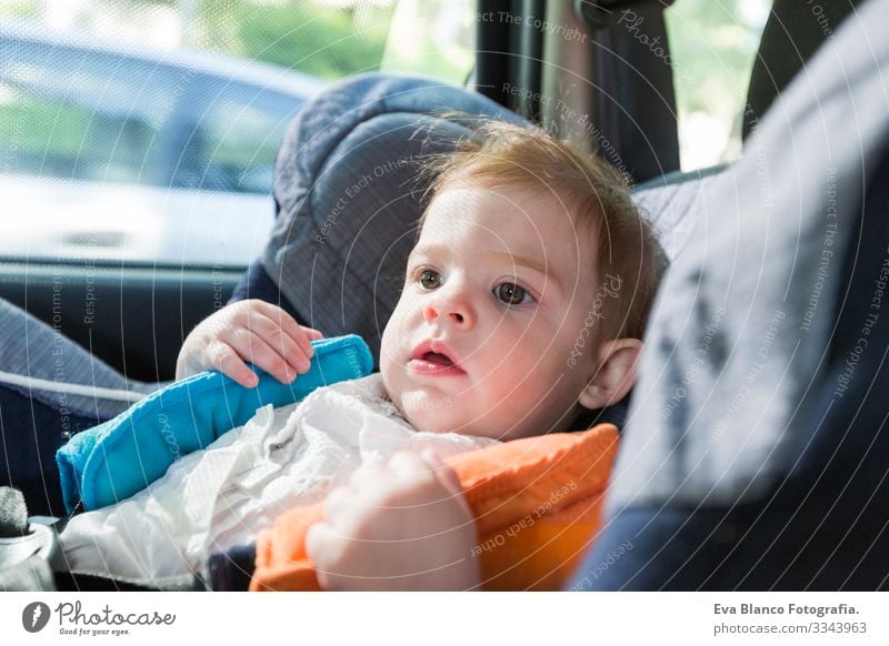cute baby blonde girl, in car seat wearing seat belts happy is going to go in the path of the road. Spring or summer season Belt Summer Small Child Contentment